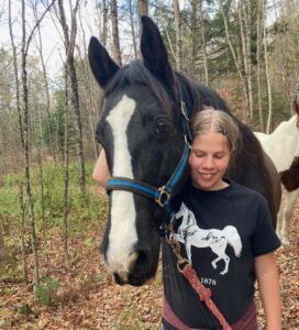 Our therapy horse, Rock, with a participant at Rhythm of the Rein in Marshfield, VT